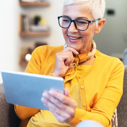 Woman using digital tablet at home