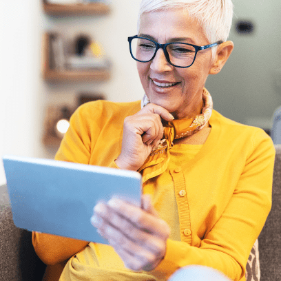 Woman using digital tablet at home